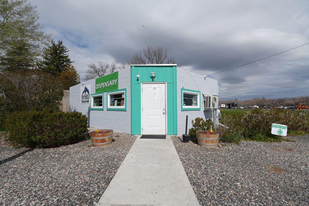 Exterior of Three Forks dispensary, MT, with visible cannabis signage and parking area.