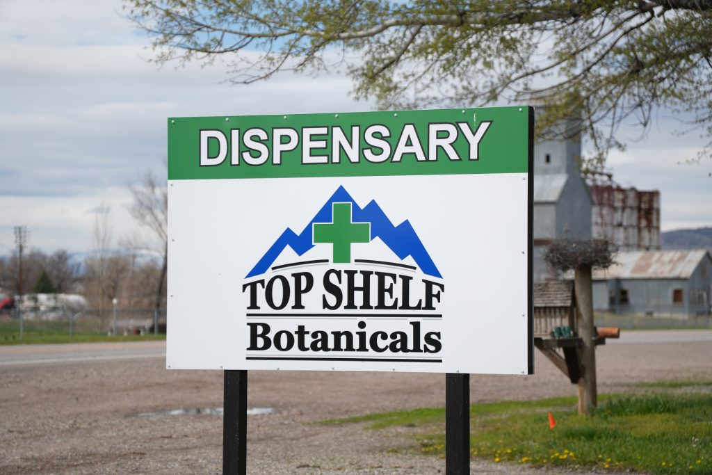 Exterior of Three Forks dispensary, MT, with visible cannabis signage and parking area.