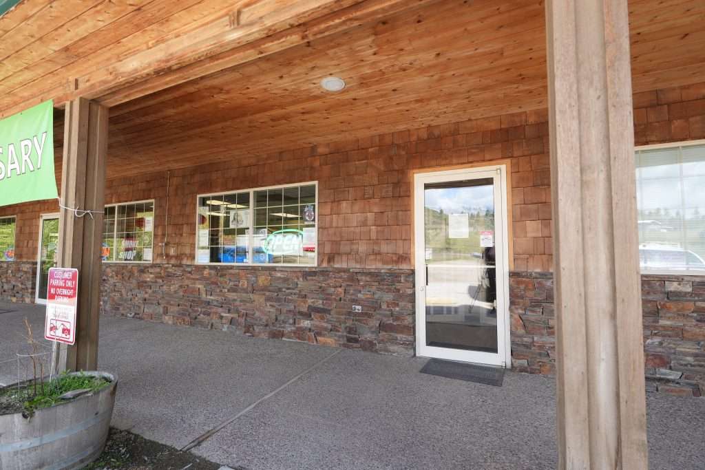 Exterior of Plains dispensary, MT, with cannabis signage and parking area.